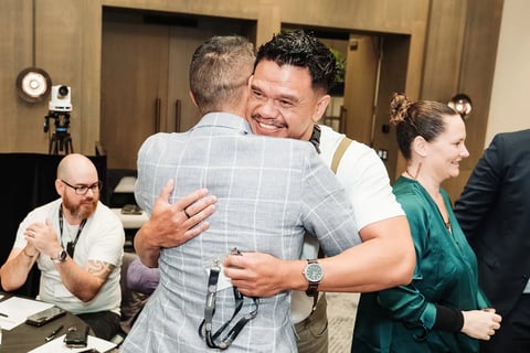 Delegates embracing at the Māori Leadership Summit 2025