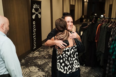 Delegates greeting each other with a hug at the Māori Leadership Summit 2025