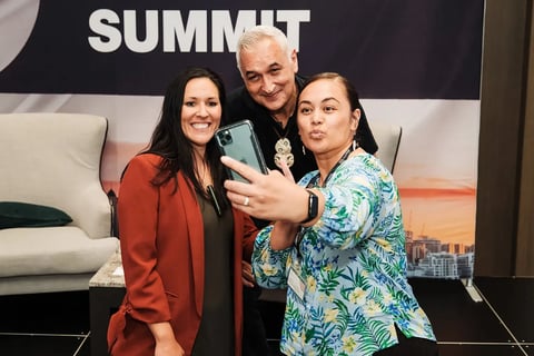 A group selfie on stage at the Māori Leadership Summit 2025