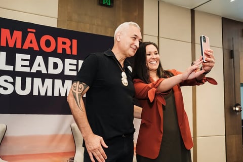 A delegate taking a selfie with a speaker at the Māori Leadership Summit 2025