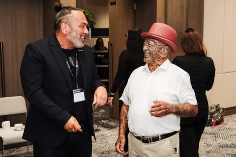 Tāme Iti sharing a laugh with a delegate at the Māori Leadership Summit 2025
