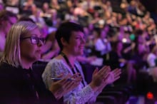 Delegates applauding a session