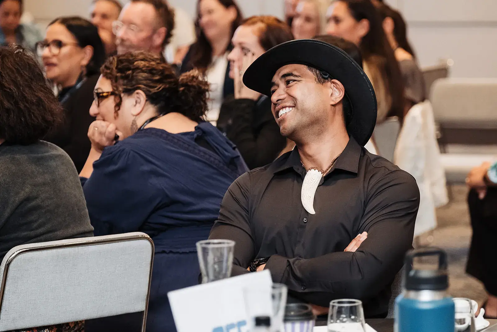 A delegate laughing during a session at the Māori Leadership Summit 2025